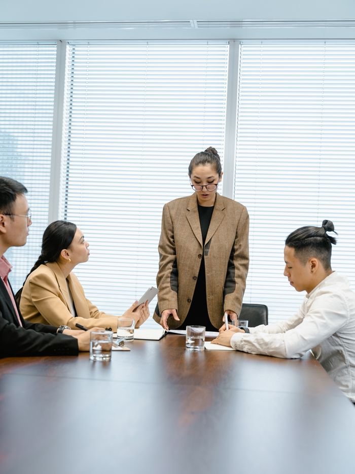 A group of professionals engaged in a business meeting in a modern conference room.